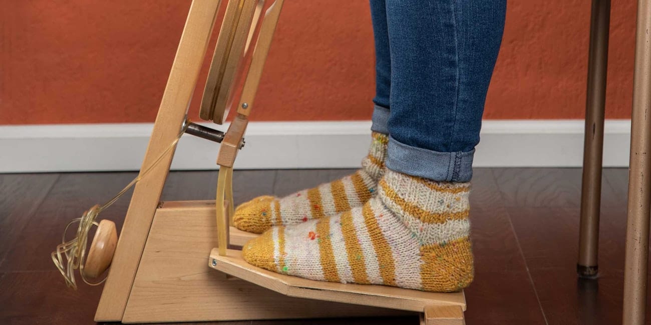 sitting at a spinning wheel